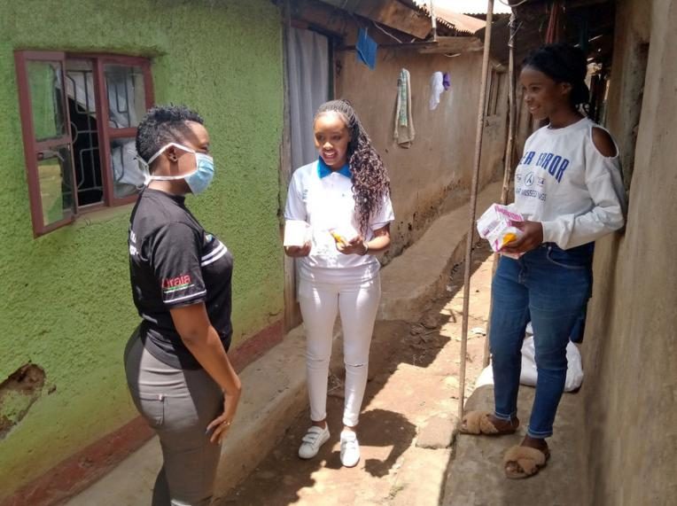 Girls from the Girls' Advocacy Alliance distribute sanitary pads in Kibera, Kenya.