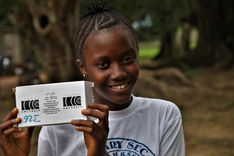 Jeneba from Sierra Leone with her solar radio.
