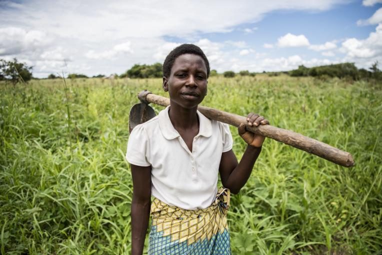 Fostina working on her crops