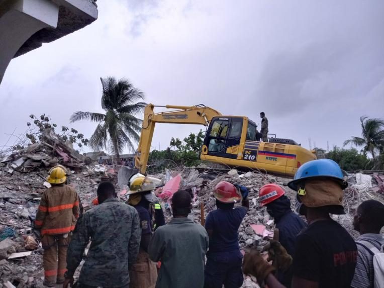 People standing looking at houses turned to rubble after Saturday's earthquake in Haiti.