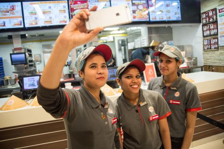 Girls taking a selfie at a fast food restaurant in Delhi