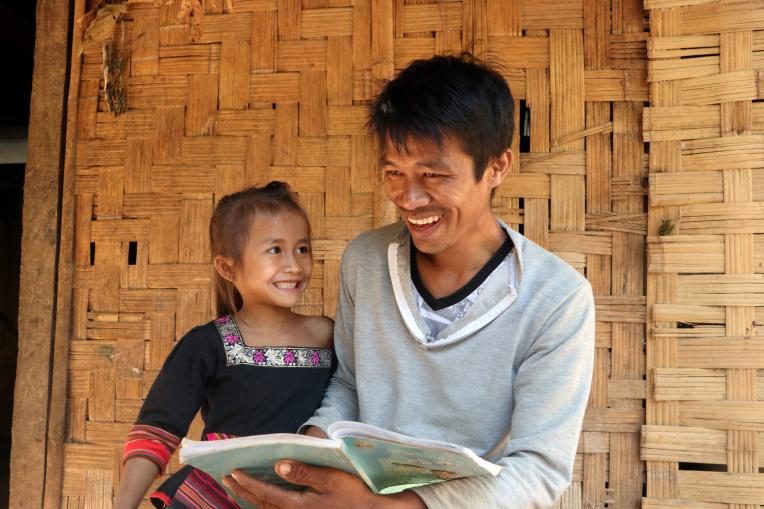 Da, 6, and her father Somnith read a book together after school.