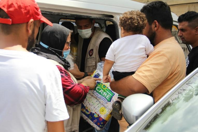 Plan International staff distribute relief aid in Karantina district, the area closest to the blast in Beirut.