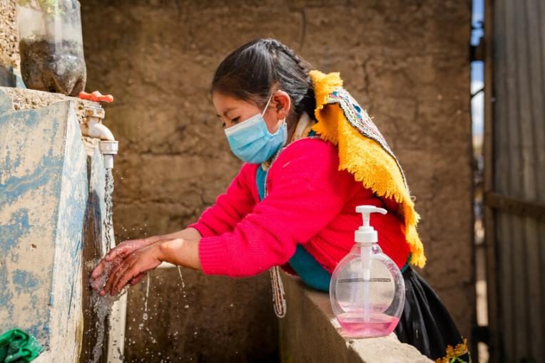A girl washing her hands in Peru
