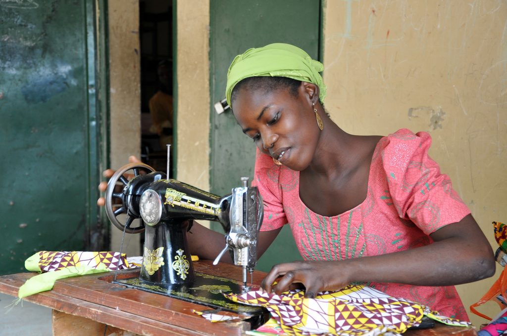 Girl learns tailoring skills at a training centre supported by Plan International .