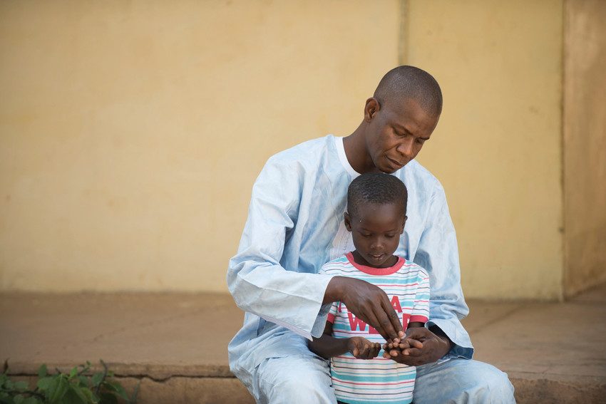 A father playing with his son in Senegal