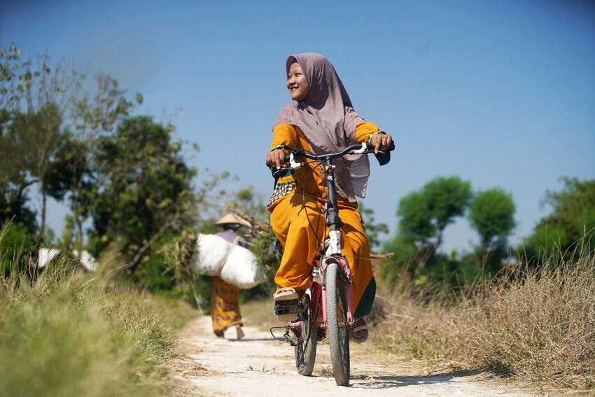Girl cycles in Rembang Regency, Central Java, Indonesia.