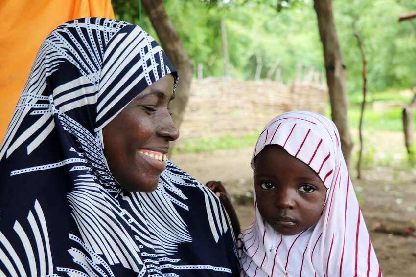 Mother and daughter at a Plan International nutrition class in Niger engaged in positive parenting.