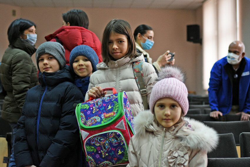 Children in Moldova with backpacks full of educational materials provided by Plan International.
