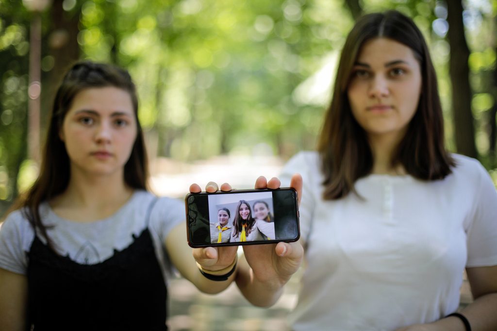 Sisters living in Romania, having fled conflict in Ukraine.