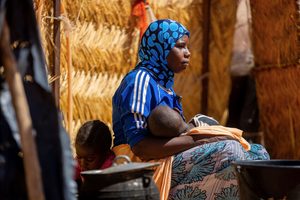 Mother comforts hungry baby in Niger.