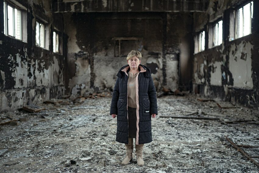 Ludmila, headteacher, in her school's fire damaged gymnasium.