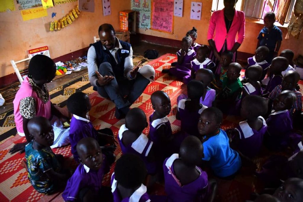 Stephen Omollo, Plan International CEO, at a 'speed school' in Uganda.