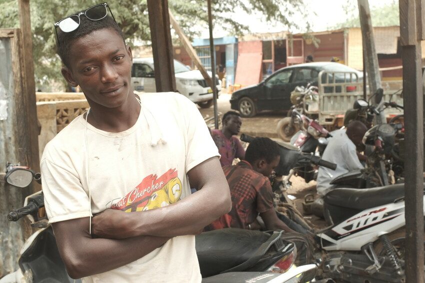 Ahmed, pictured at the garage he works at thanks to skills training with Plan International. 