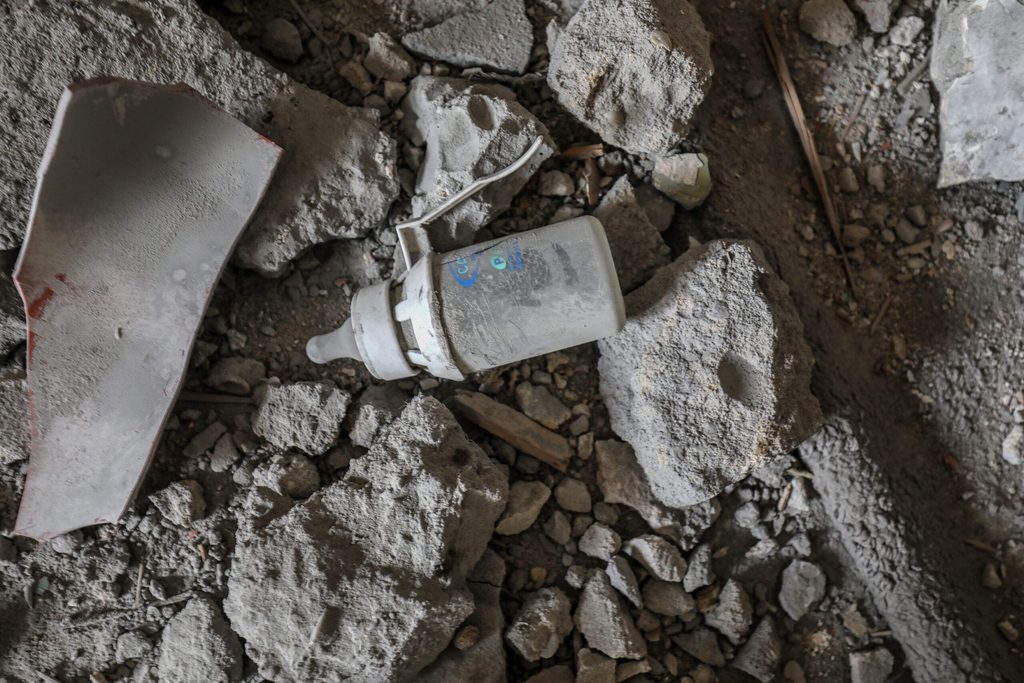Baby bottle amid rubble of ruined municipality building following an air strike in the city of Khan Yunis, south of Gaza.