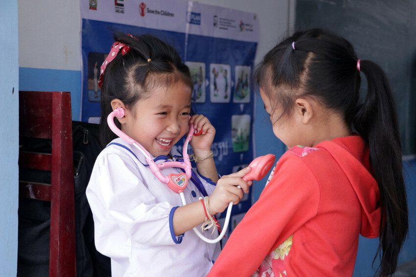 Five-year-old Anna is busy plays at being a doctor for her friend in Laos' Oudomxay Province