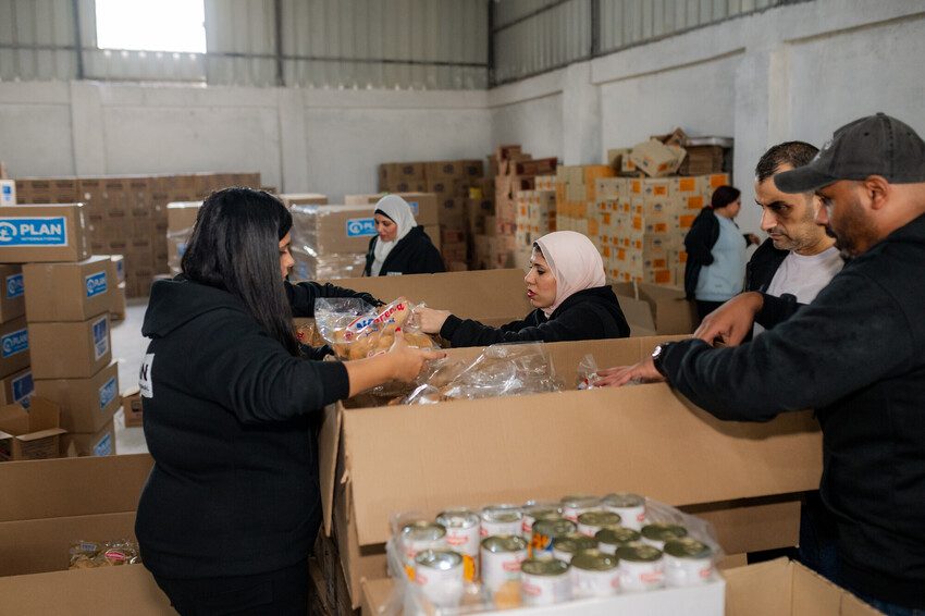 Plan staff are packing boxes with relief aid for Gaza. 