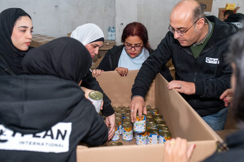 Plan International Egypt staff prepare relief aid for transportation to Gaza