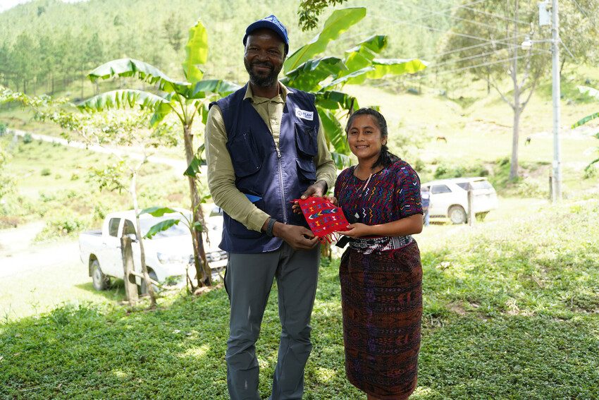Stephen Omollo receives gift from girl leader in Guatemala.