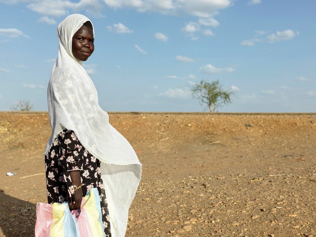 Julua, 18, has just arrived from Mukhaib in Sudan with just a small bag. Photo credit: Plan International / Peter Caton.