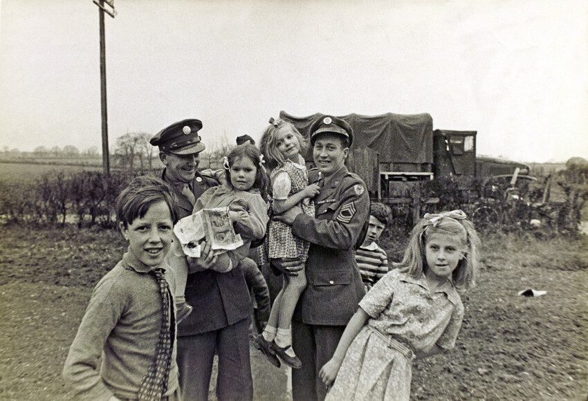 Children with the army officers. Black and white photo 1944. 