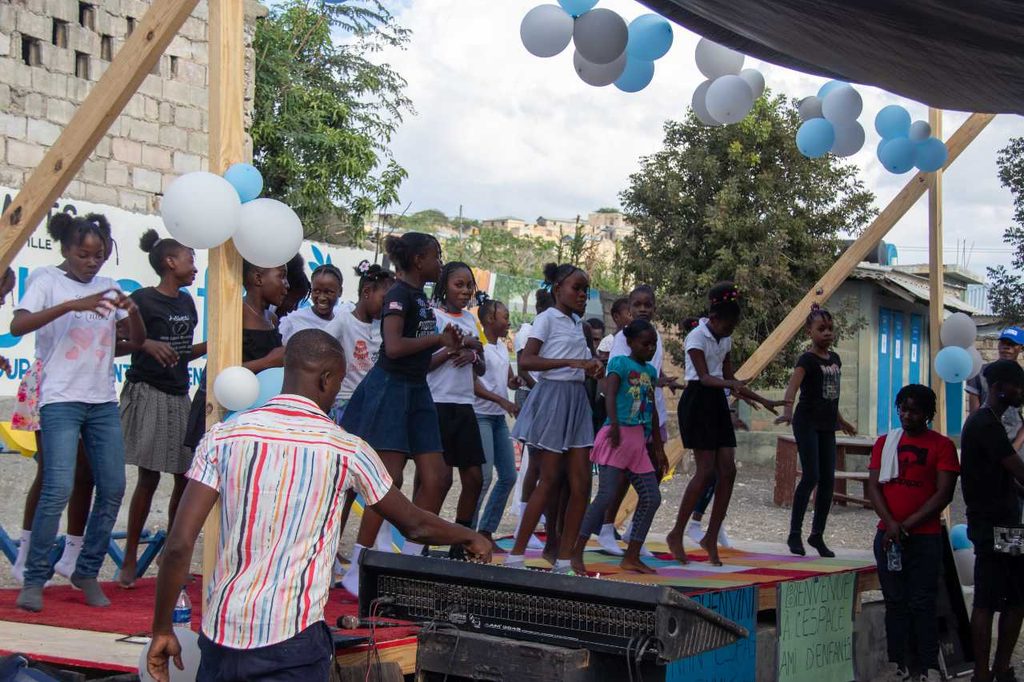 Girls take part in a show at the child-friendly space.