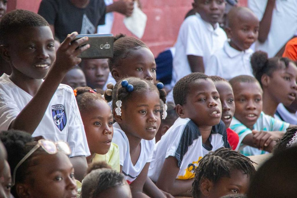 Children sitting and watching a show. 