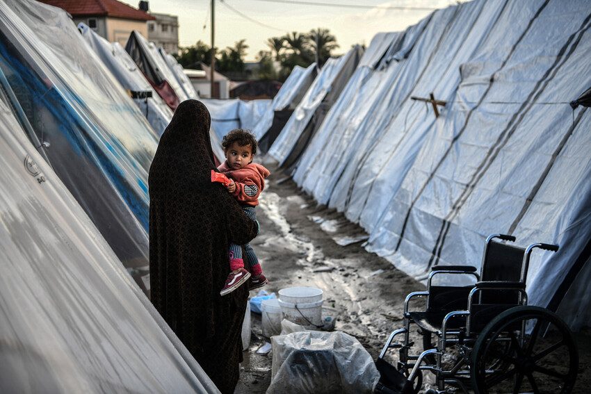 Mother and child amid the tents in Rafah, southern Gaza.