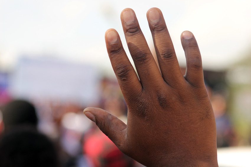 A person raising their hand in Malawi