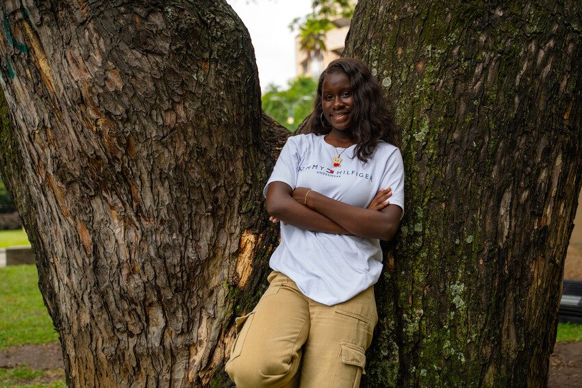 Ada Luz smiles with her arms folded. 