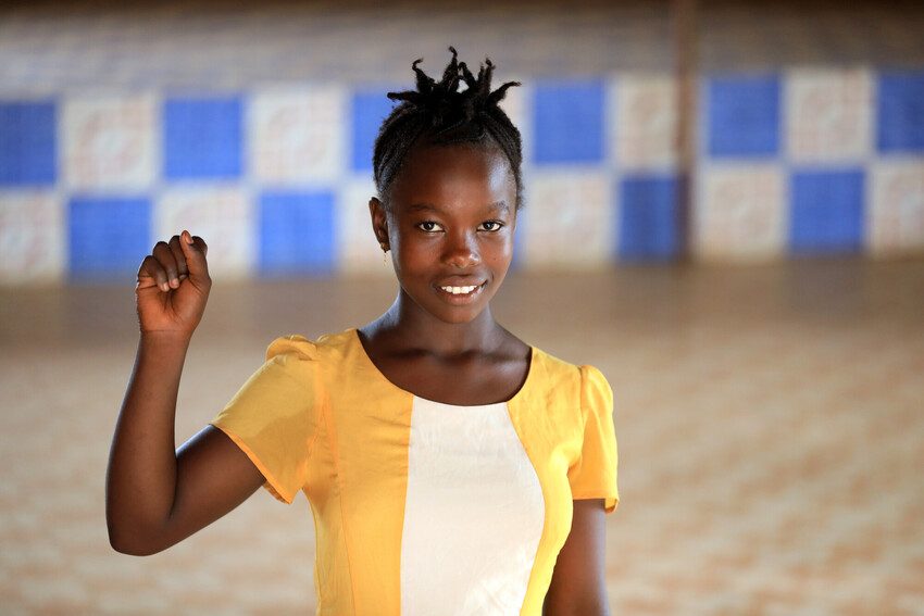 Kadiatu from Sierra Leone raises her fist in defiance.