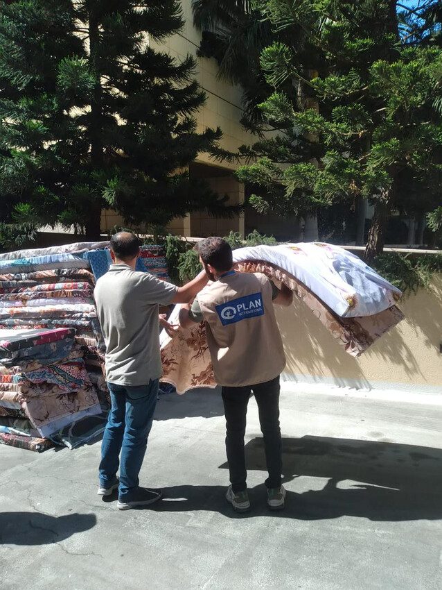 Plan staff deliver supplies like water and hygiene kits to children and families forced to flee their homes.