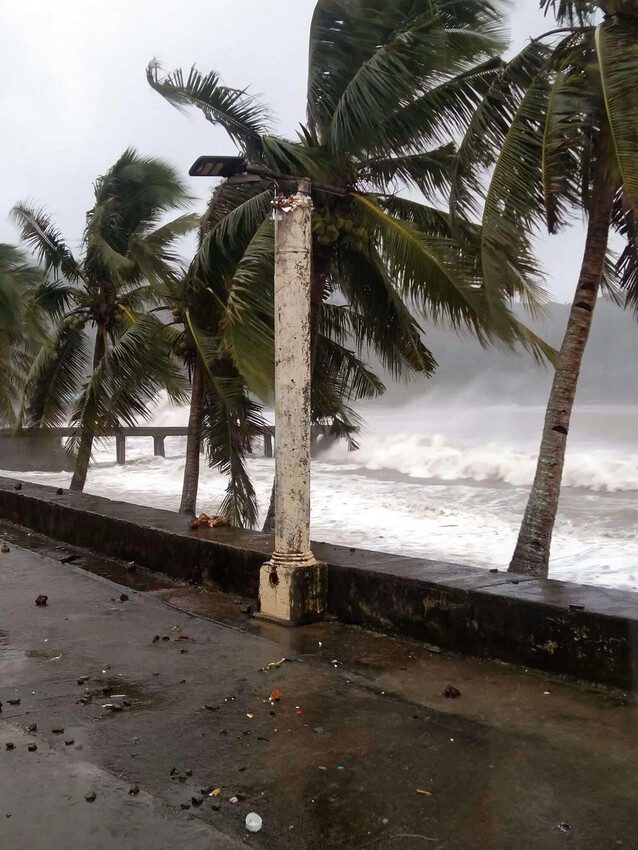 A very large wave is approaching the shore. 