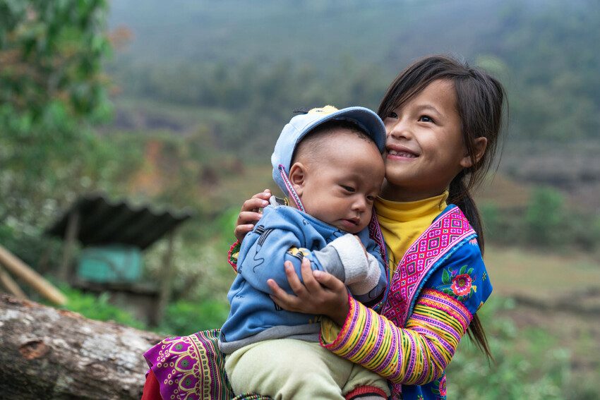 Sister plays with her little brother in Lai Châu Province, Vietnam