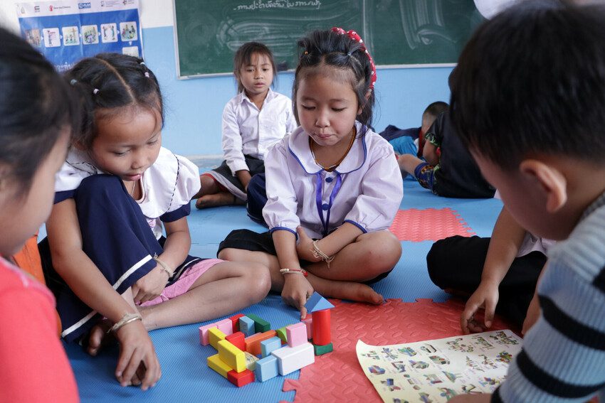 Anna, 5, and her friends play with colourful building blocks