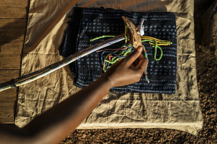 The traditional “pagne” (loincloth) and “baton” (stick) worn by girls during festive ceremonies, which used to include the FGM cutting ceremonies. Nowadays, they are only used for wedding ceremonies.