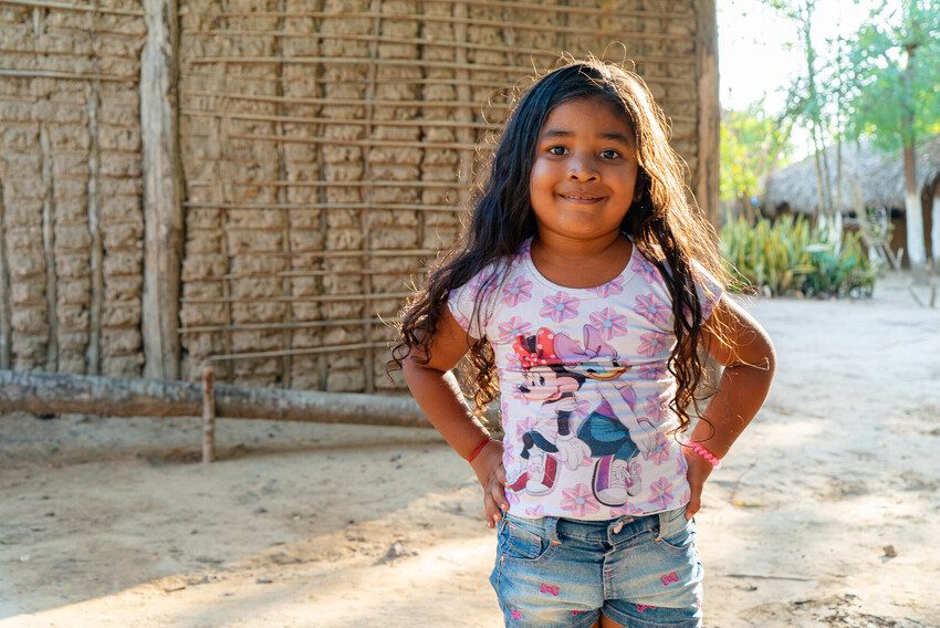 Vitória, 4, Brazil stands in front of her home.