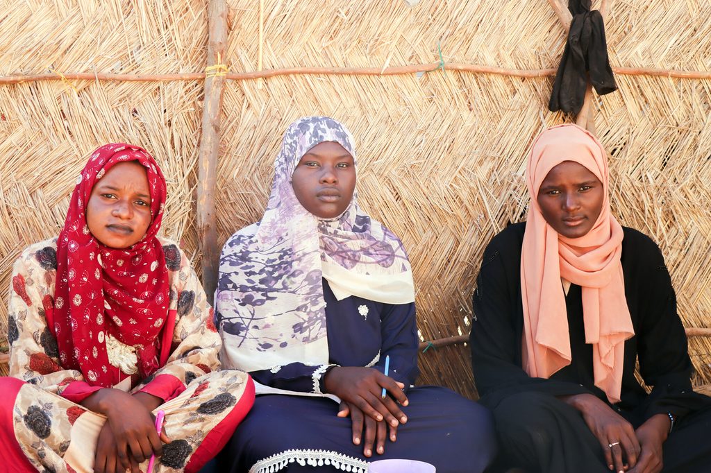Nancy, Mehad and Weam sit outside a tend in the internally displaced persons camp where they currently live.
