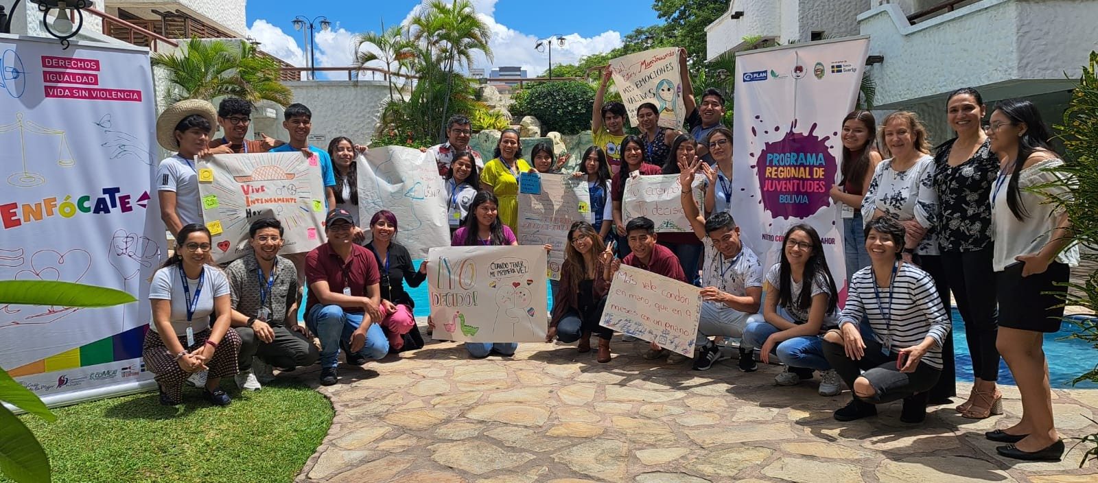 A group of adolescents in Bolivia stand with posters they made during an embracing pleasure workshop. 