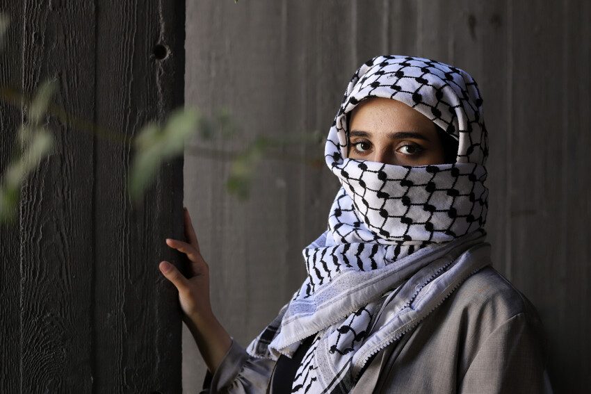 Woman in a keffiyeh.