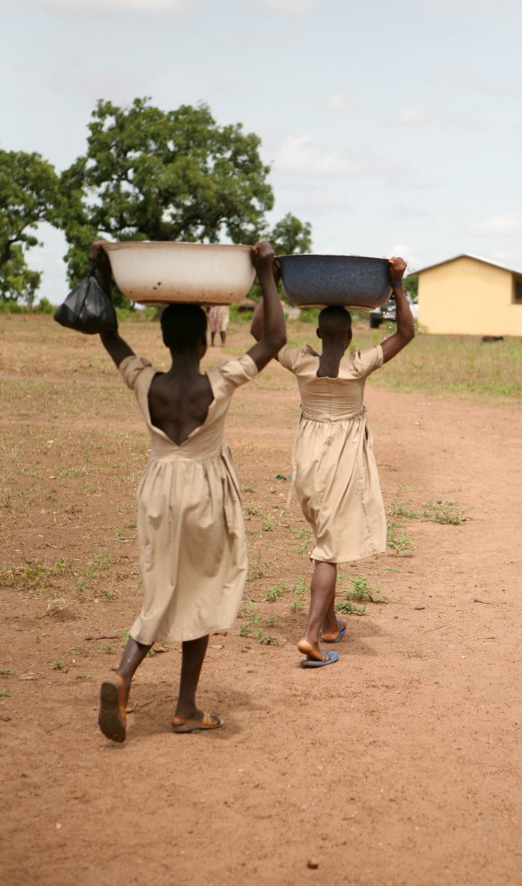 Girls carry water to their village.