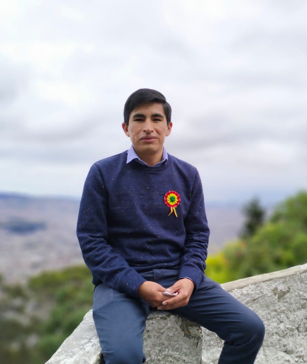 Walberto sitting on a rock.