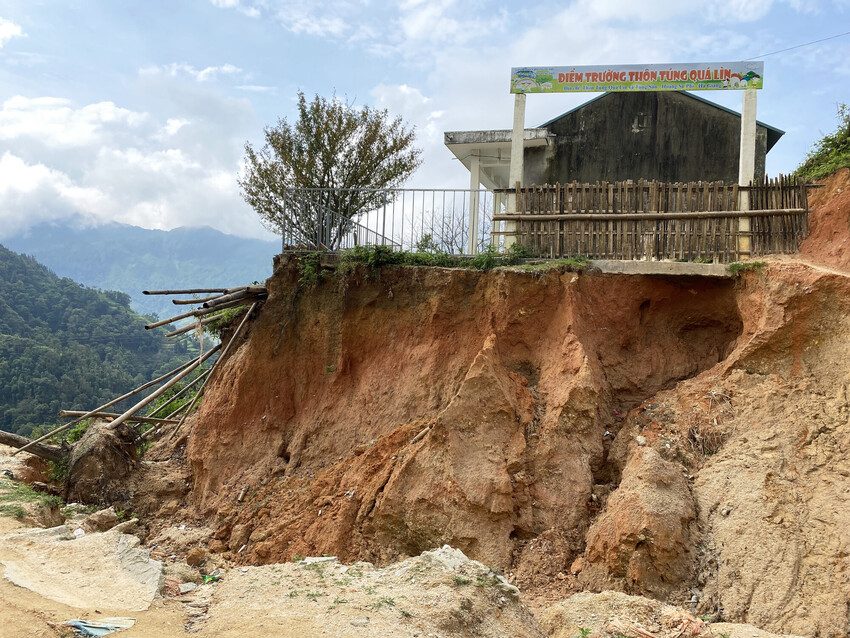 A school sits at the top of a hill on the edge of a ravine created by Typhoon Yagi. 