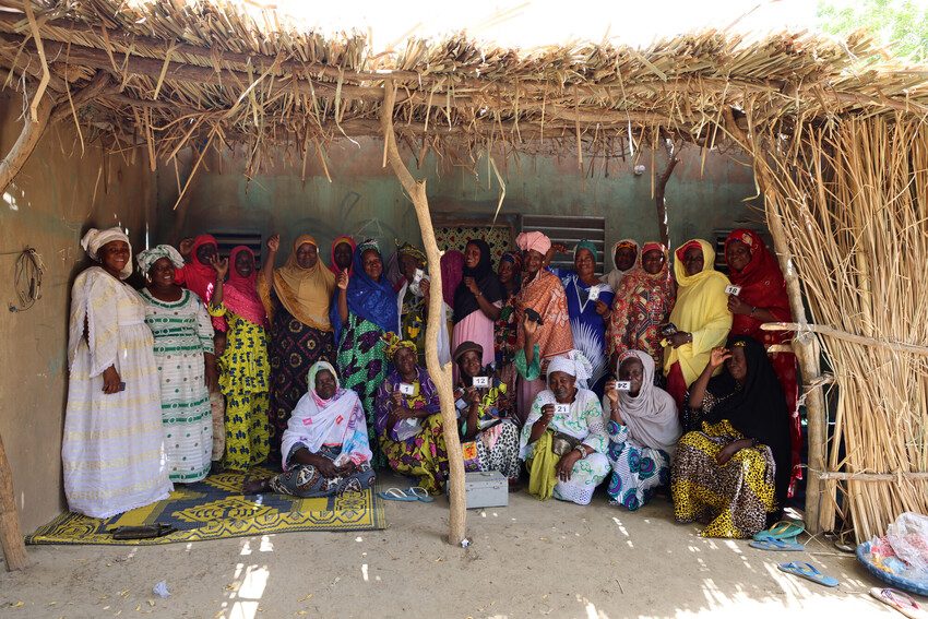 A group of women from the associations sitting and standing together as a group. 