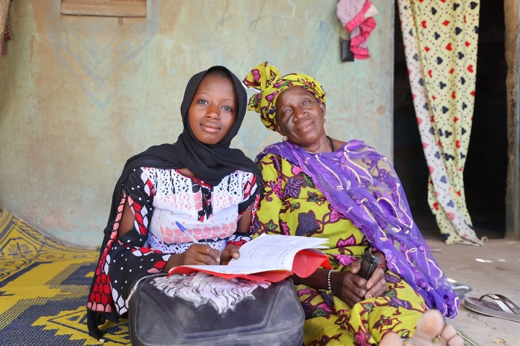 Mahawa and her mother sit next to each other.