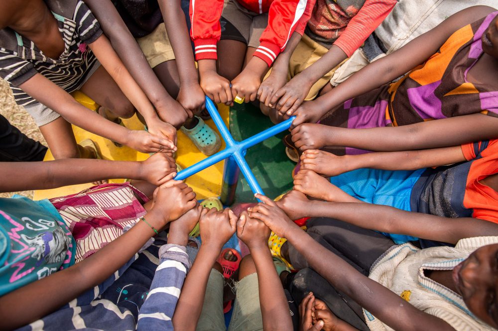 Children play on roundabout in refugee camp in Gatsibo district, Rwanda
