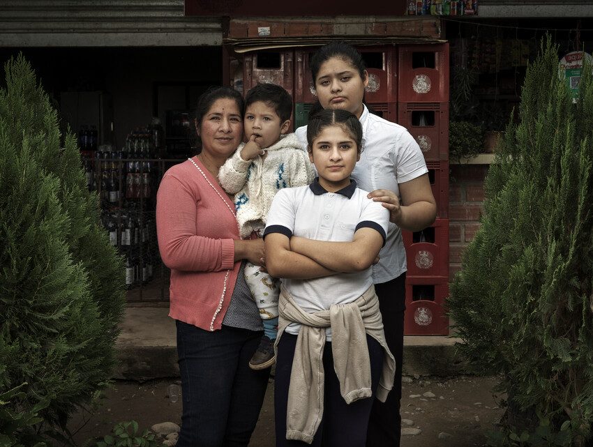 Dalita holds close the 3 children she raises on her own. 