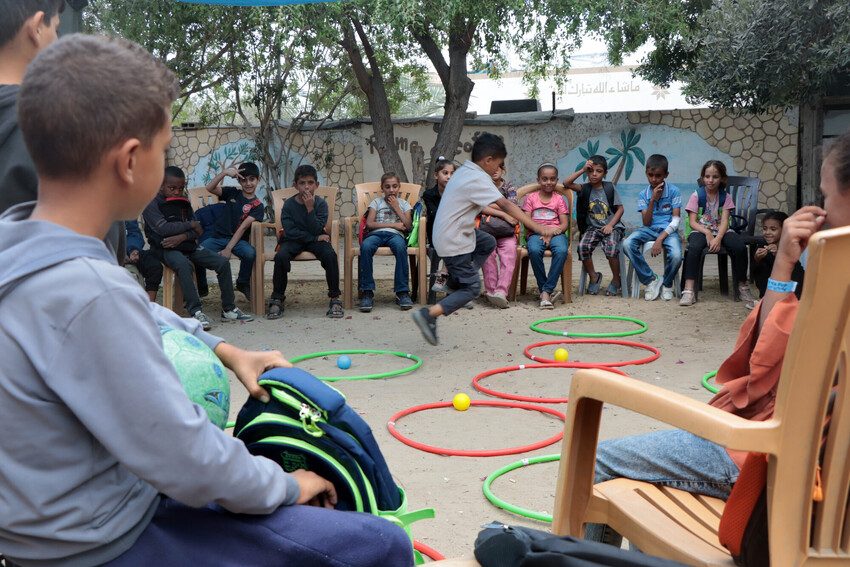 Children play games at learning space in Gaza.