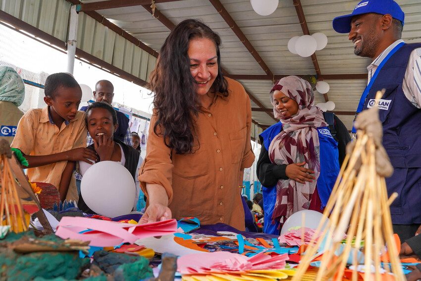 Plan staff distribute humanitarian aid to children and families in Sudan.