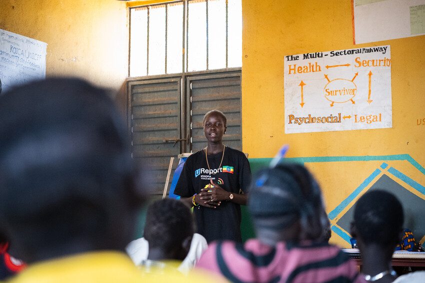 Nyari speaking to her peers about issues they face in their refugee camp
